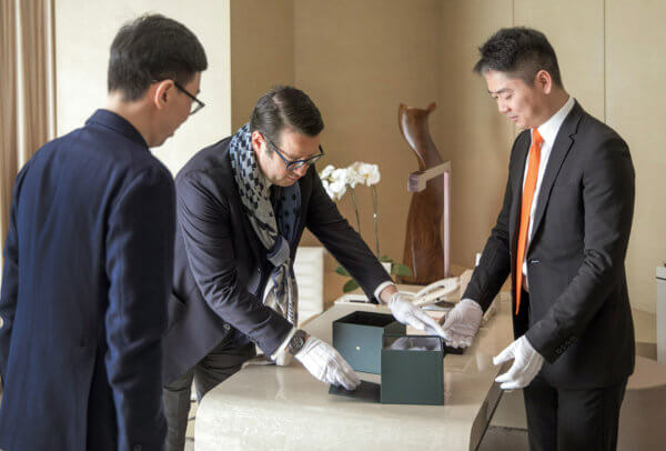François-Henry Bennahmias (CEO of Audemars Piguet) and Richard Liu (founder of JD.com) deliver the watch to the buyer