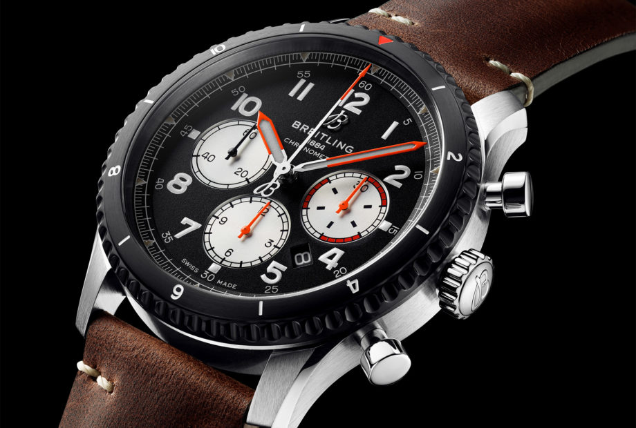 The Breitling Aviator 8 Mosquito Night Flight bears the red and orange accents of the roundels and markings on the fuselage of the De Havilland Mosquito aircraft.